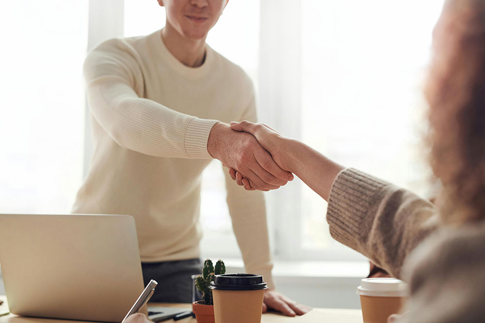 Man and woman shaking each other's hand.